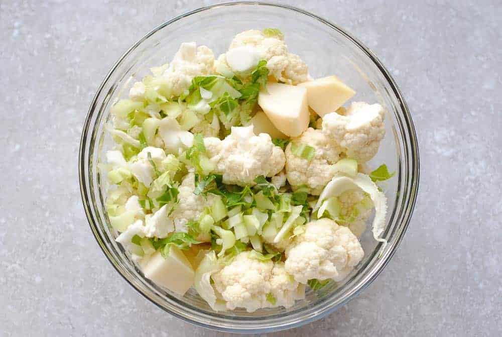 cauliflower florets and potato in a glass bowl