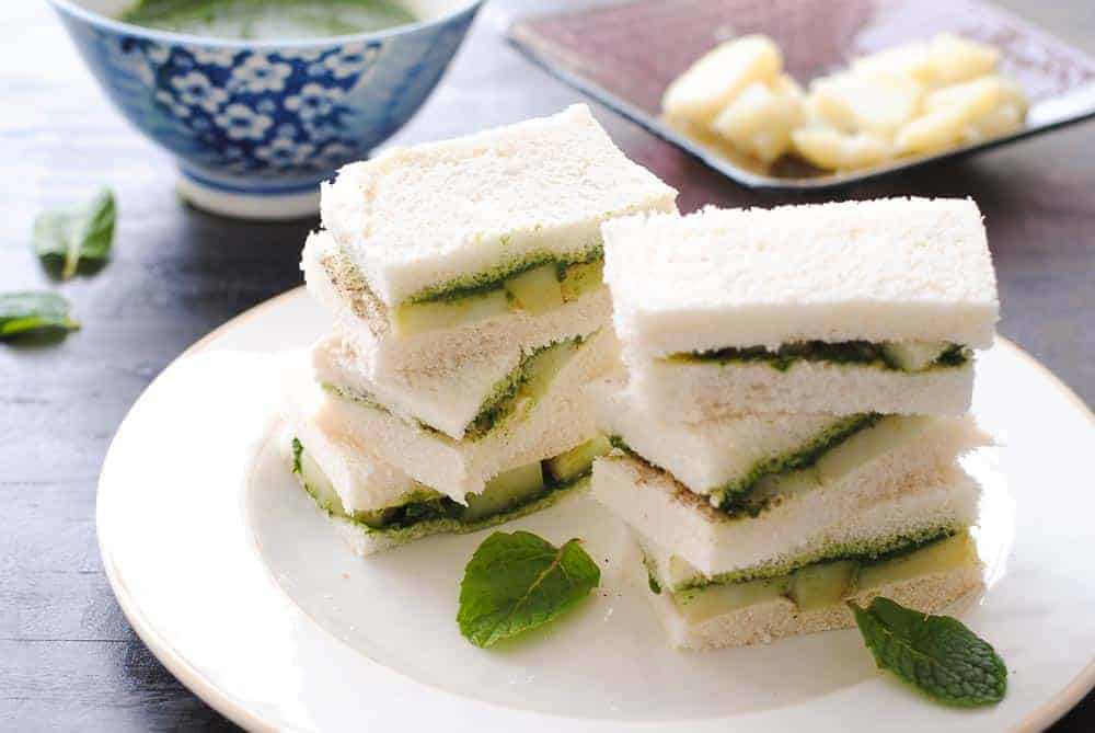 Chutney sandwiches stacked on a platter.