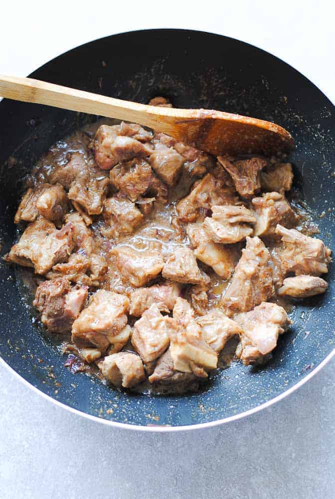 lamb cooking in a wok