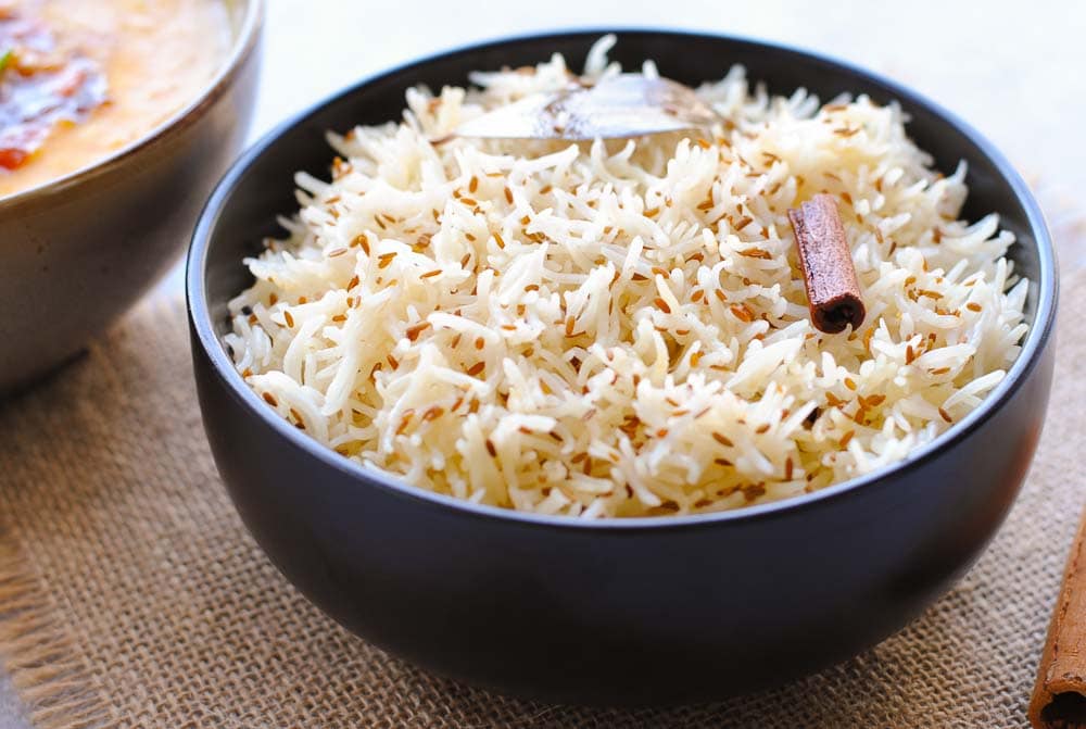 jeera rice in a black bowl