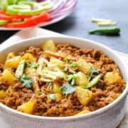 keema aloo (mince with potatoes) in a dish with salad on the side