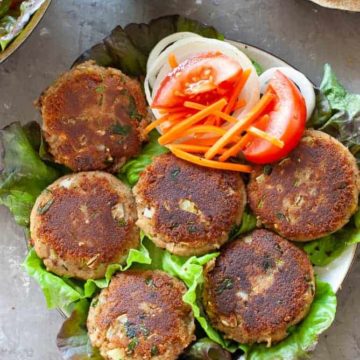 shami kabab on a bed of lettuce and salad