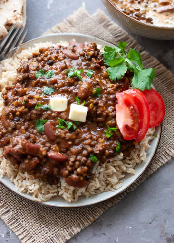 dal makhani in a bowl with naan on the side
