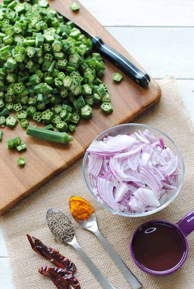 Ingredients for bhindi sabzi - okra, onion, oil, turmeric, cumin and dry chilli