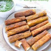 paneer fingers on a plate with green chutney in a small white bowl on the side
