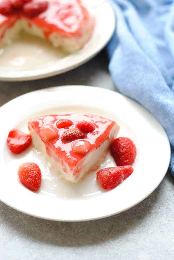mishti doi in a white plate with strawberries