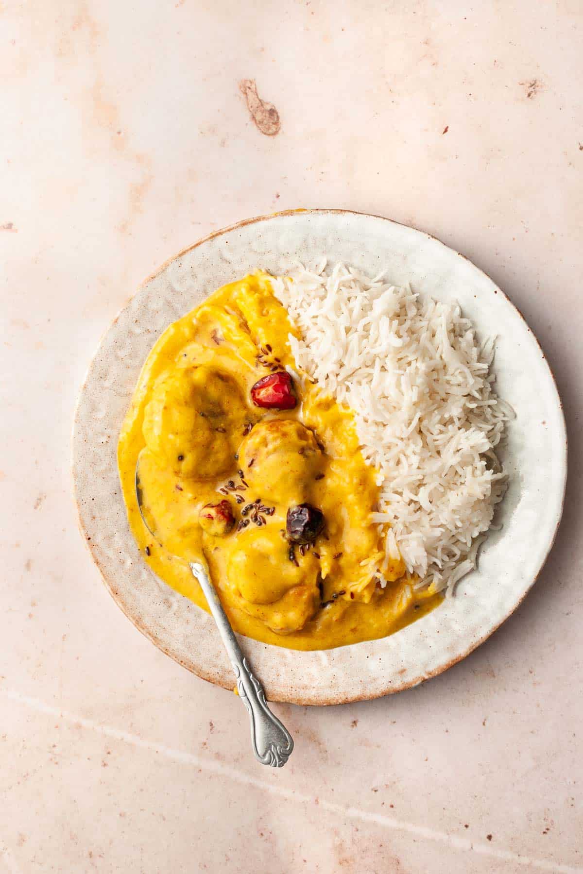 Kadhi over rice in a plate.