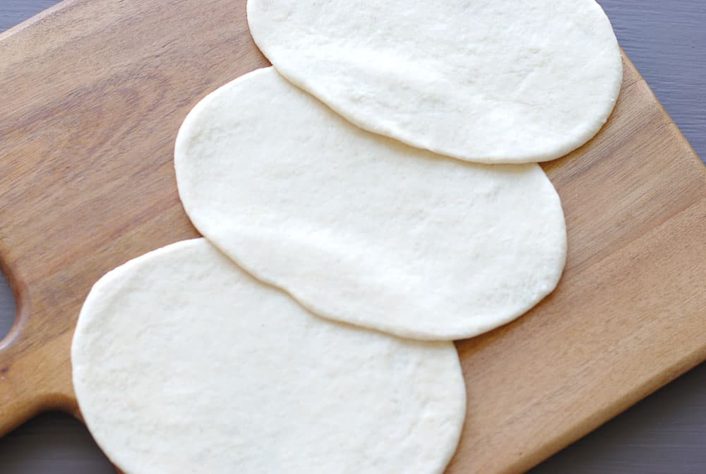 bhatura dough shaped into oblong discs