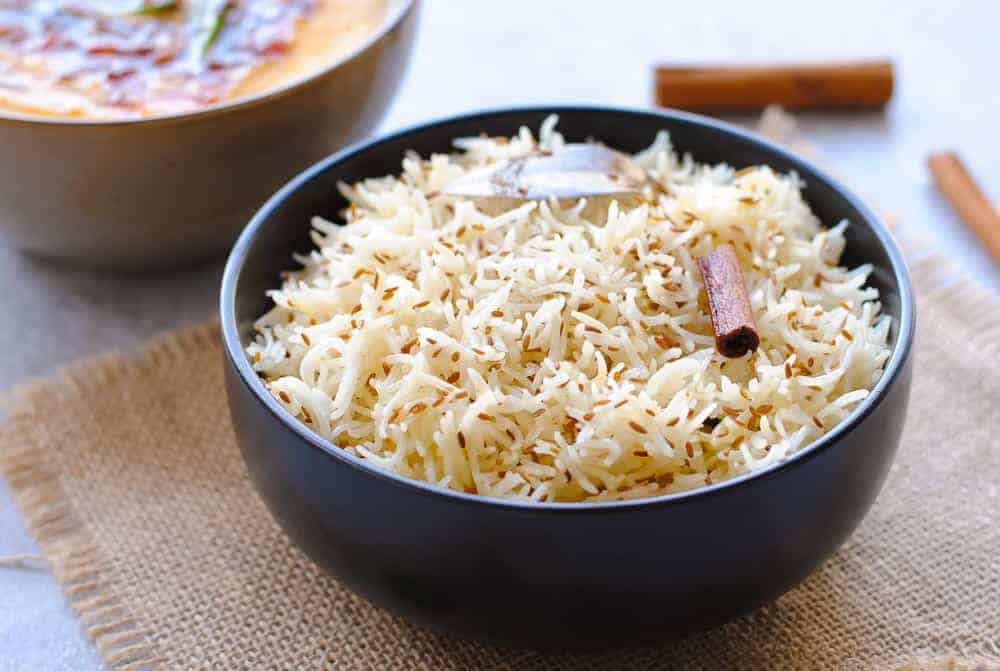 jeera rice in a black bowl