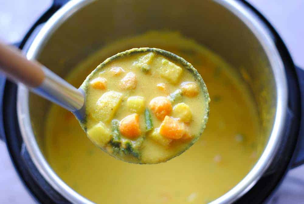 vegetable korma in a big spoon over the instant pot
