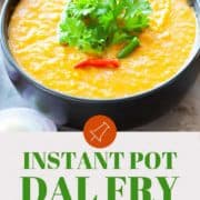 dal fry topped with parsley and chillies in a black bowl