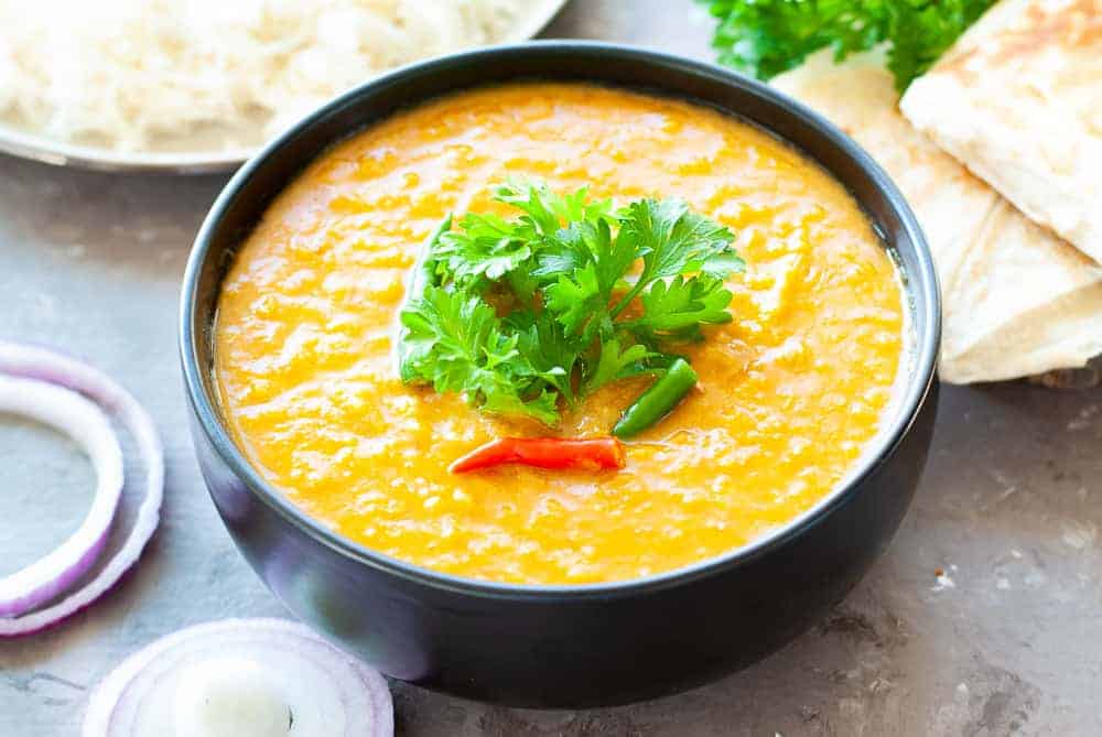 dal fry in a black bowl