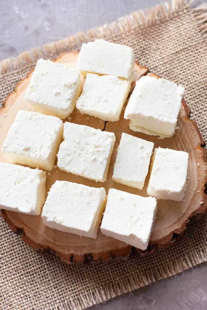paneer cubes on a wooden block