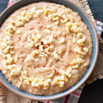 rice kheer topped with slivered almonds in a bowl
