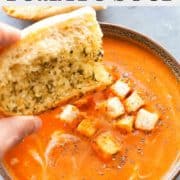 tomato soup in bowl with a piece of bread over it
