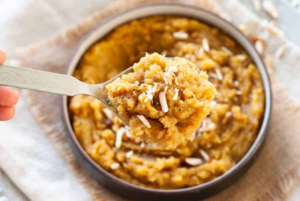 Moong Dal halwa in a spoon over a bowl