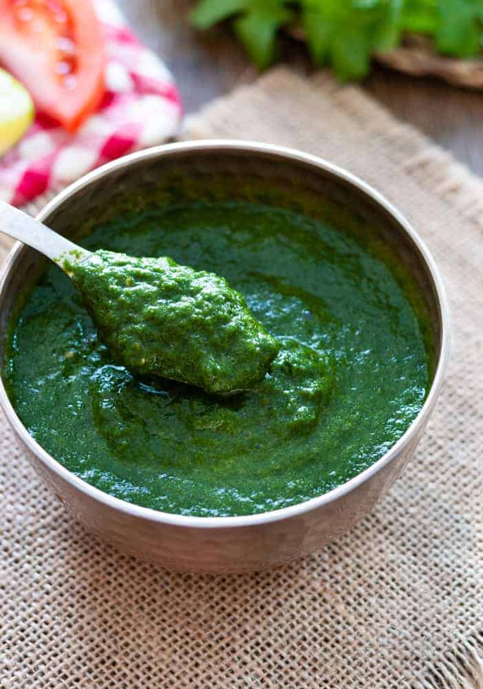 cilantro chutney in bowl with a spoon