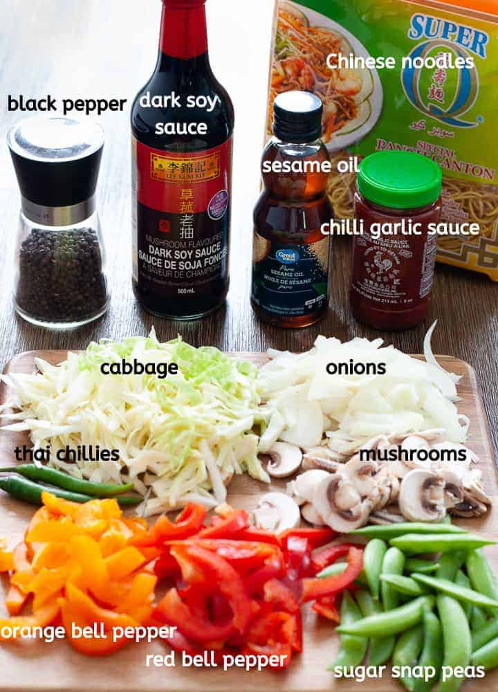 Vegetable lo mein ingredients on wooden platter