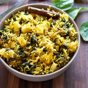 spinach rice with Indian cottage cheese in a bowl