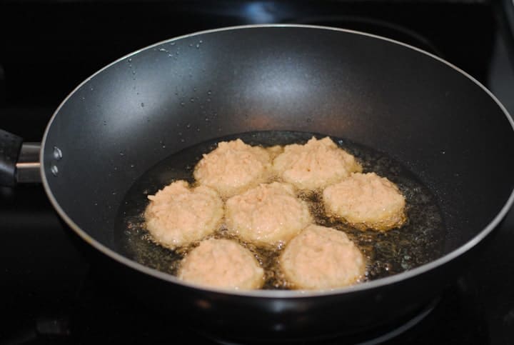 lentil balls frying in hot oil in wok
