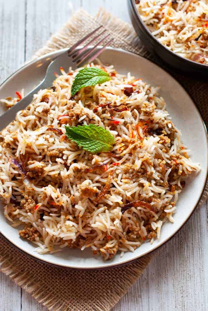 keema biryani in a plate with a fork on the side