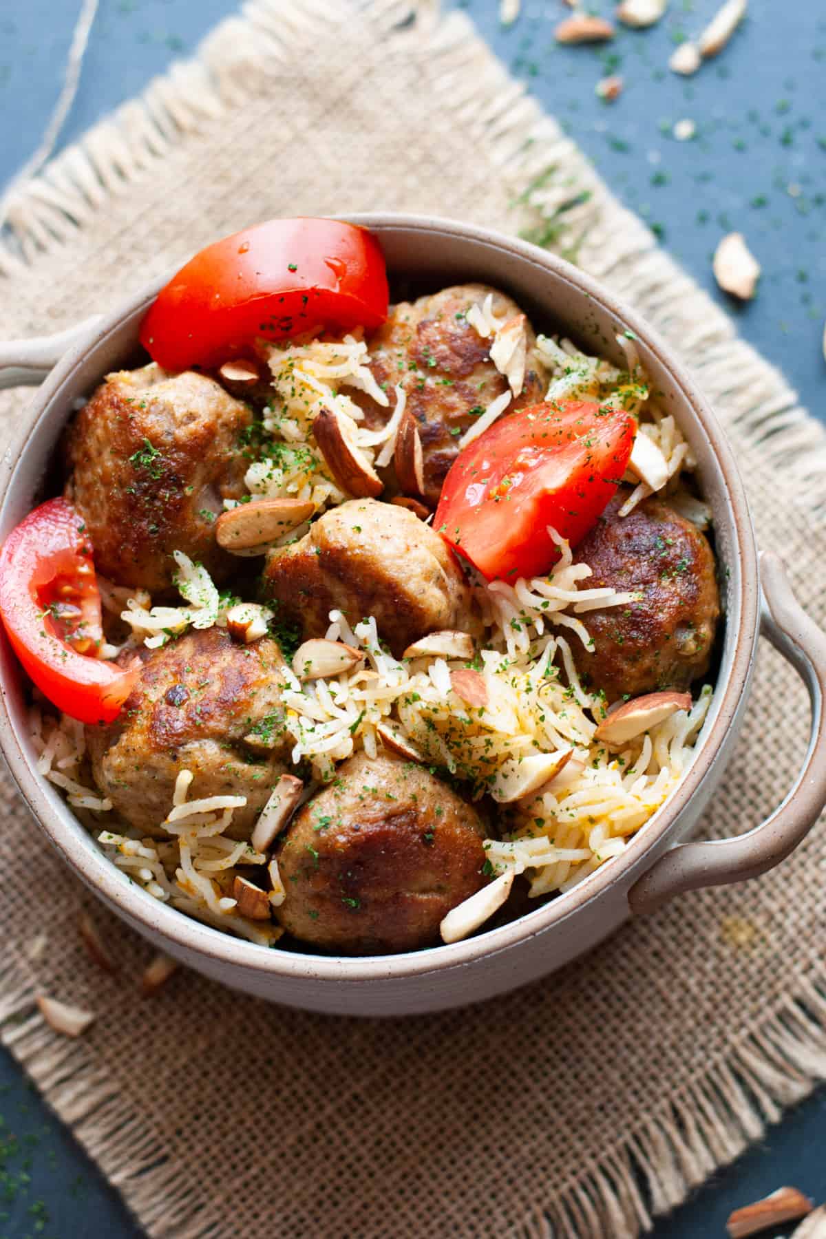spiced chicken meatballs over rice in bowl