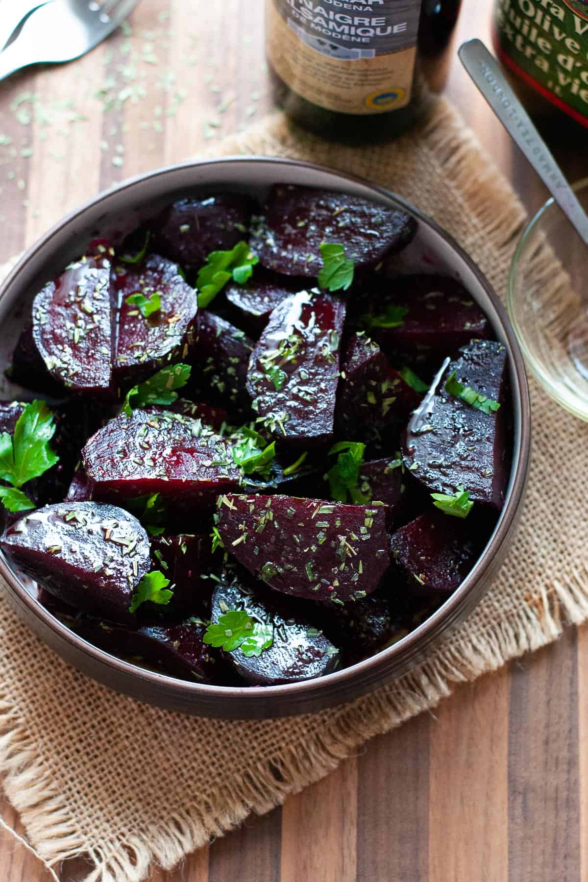 cooked and dressed beets in a bowl
