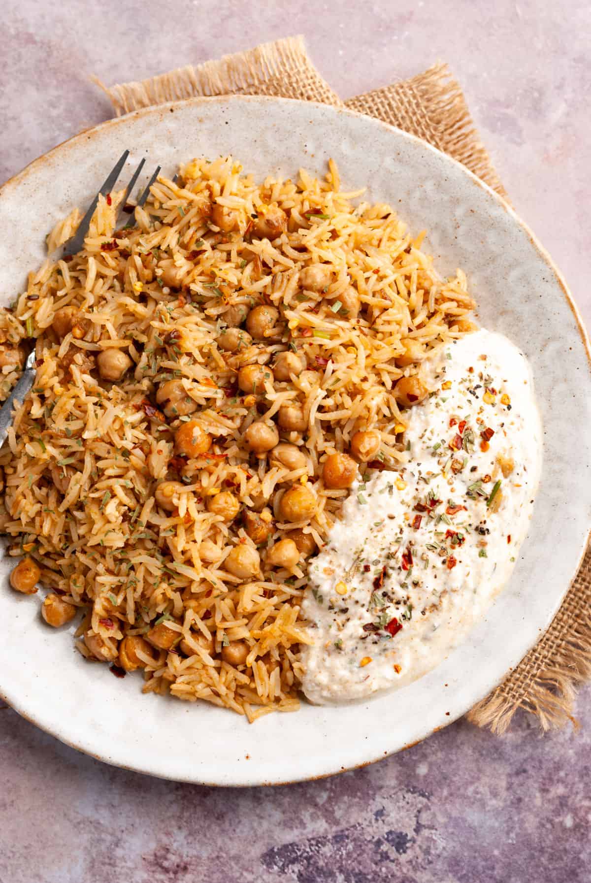 Chana Pulao in plate with fork and raita