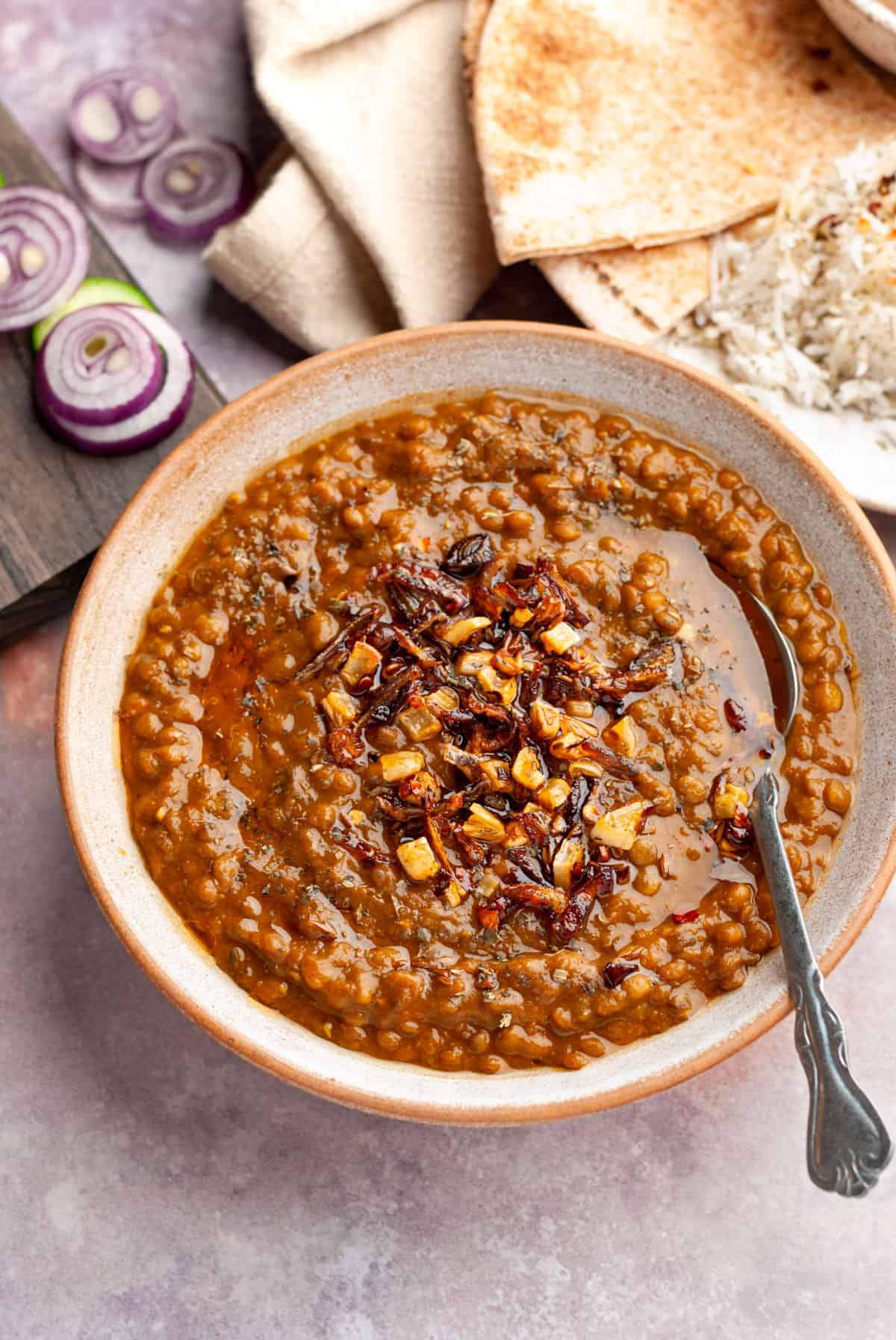 whole masoor dal in bowl with spoon

