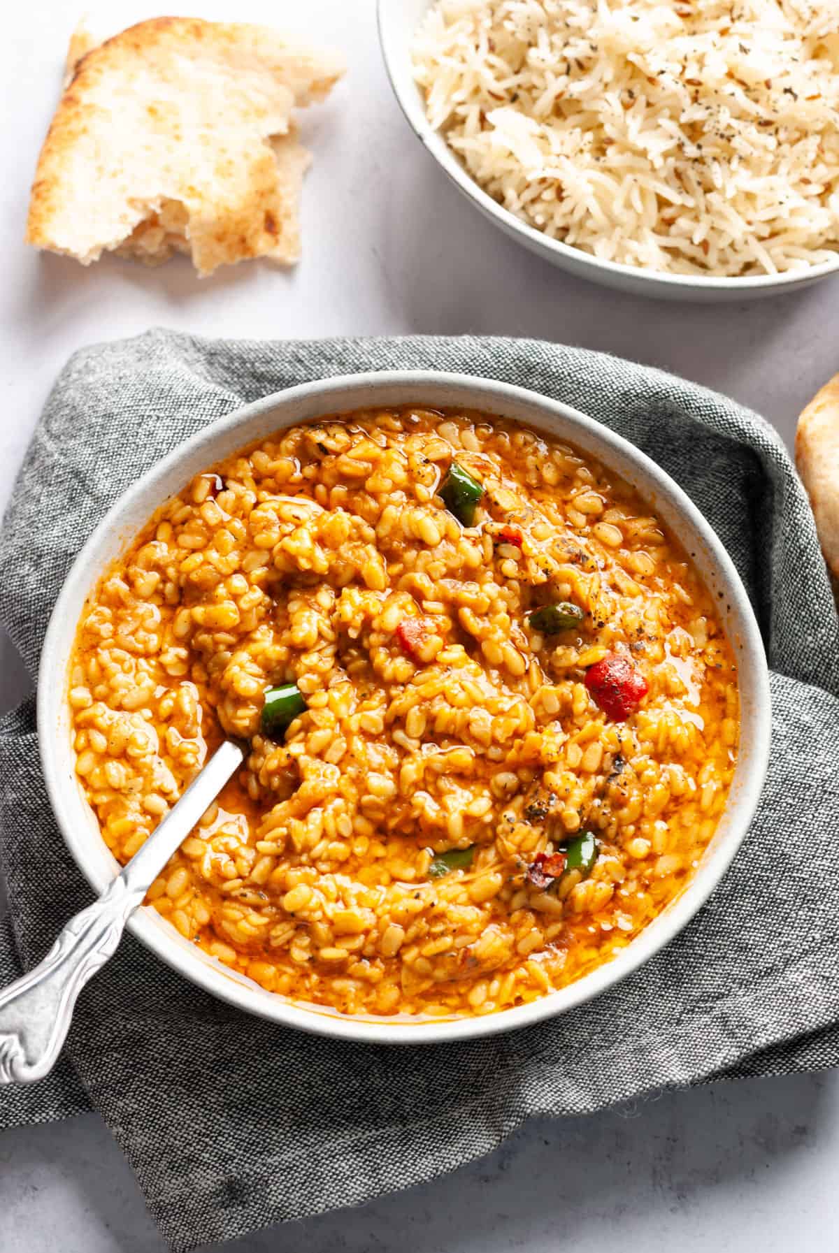 maash ki dal in grey bowl with spoon