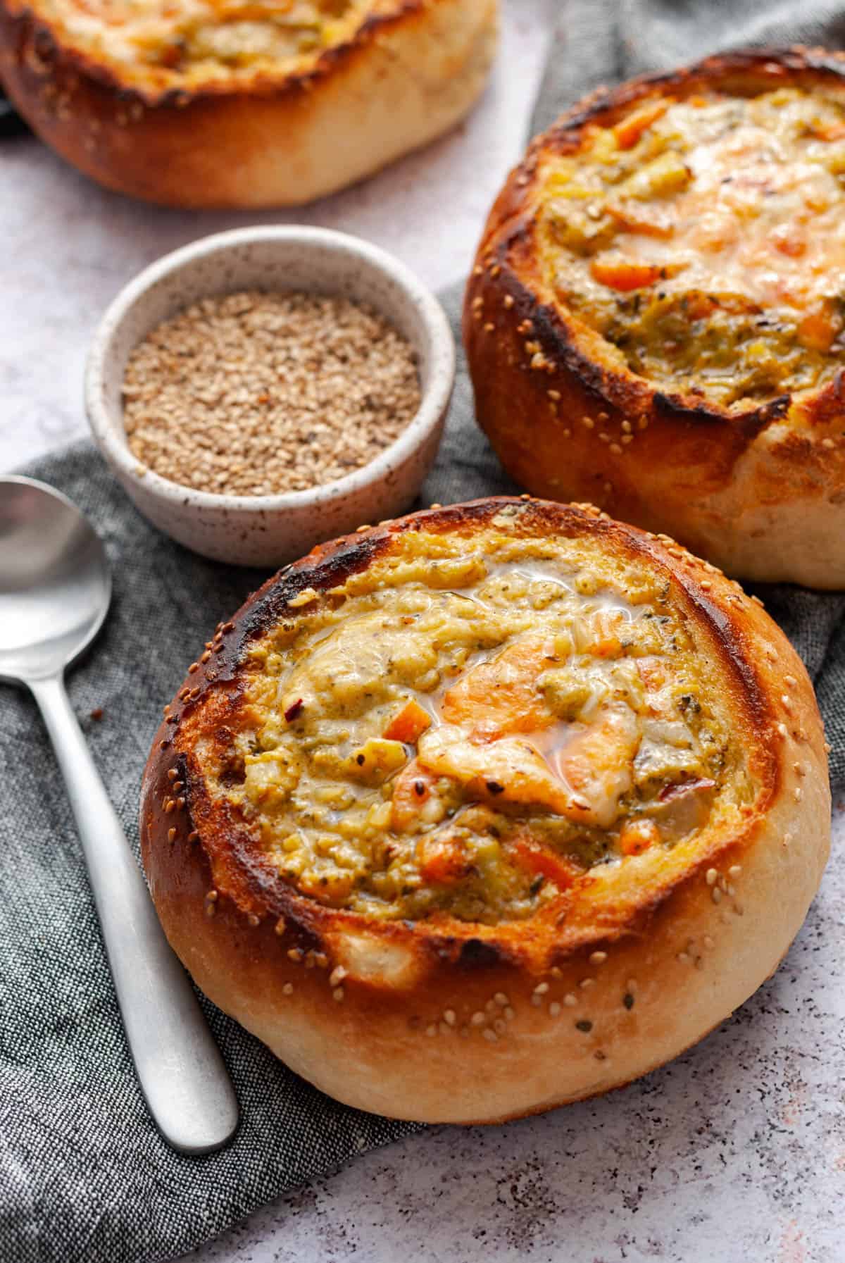 bread bowl with soup and spoon on the side 