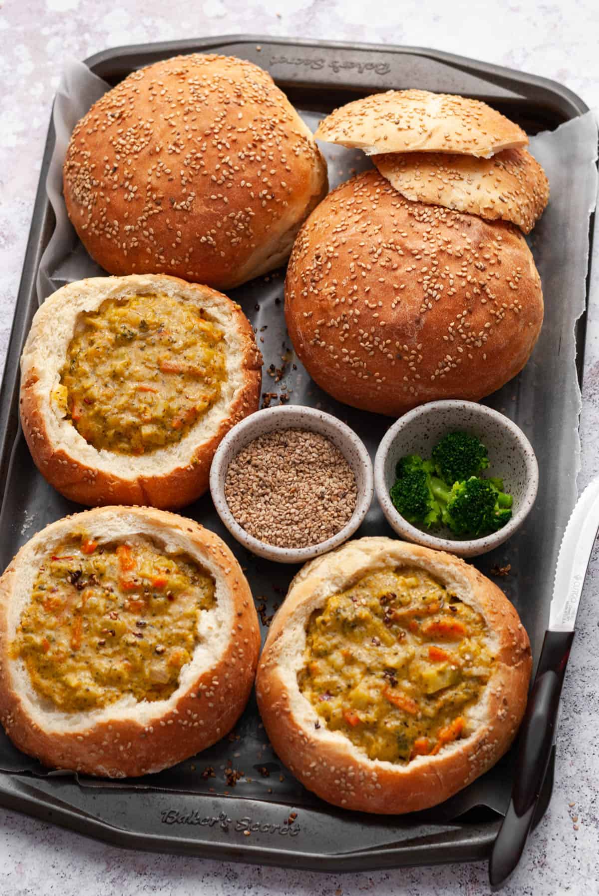 bread bowls with soup on a baking tray