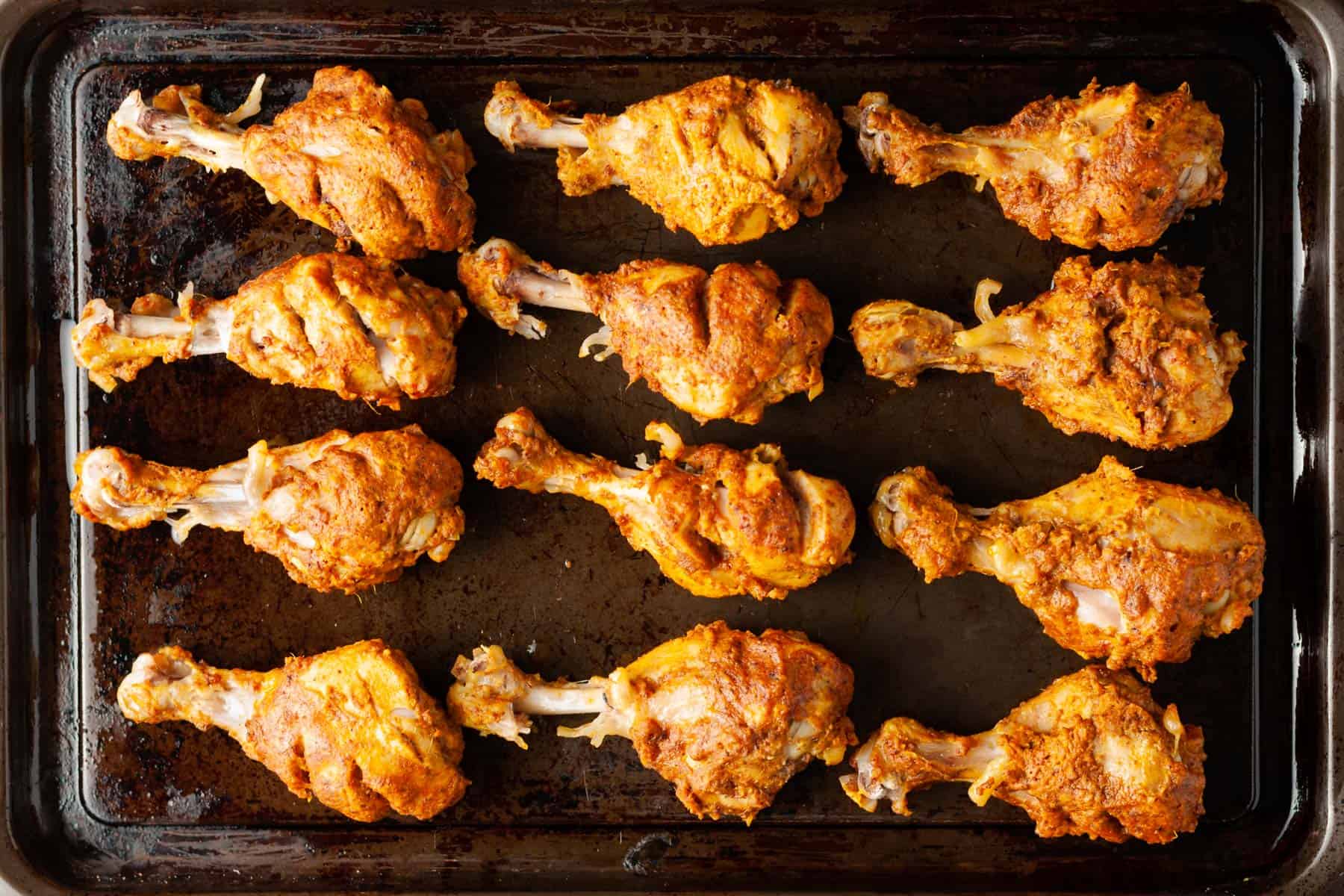 tandoori chicken legs on a sheet pan