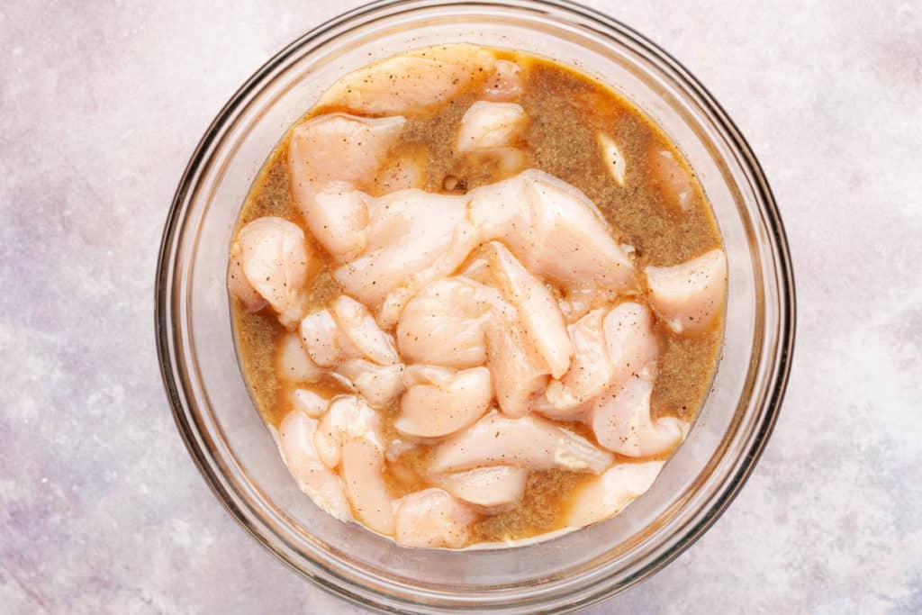 chicken strips marinating in a bowl