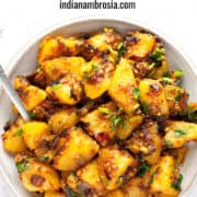 dry aloo sabzi in a bowl with spoon