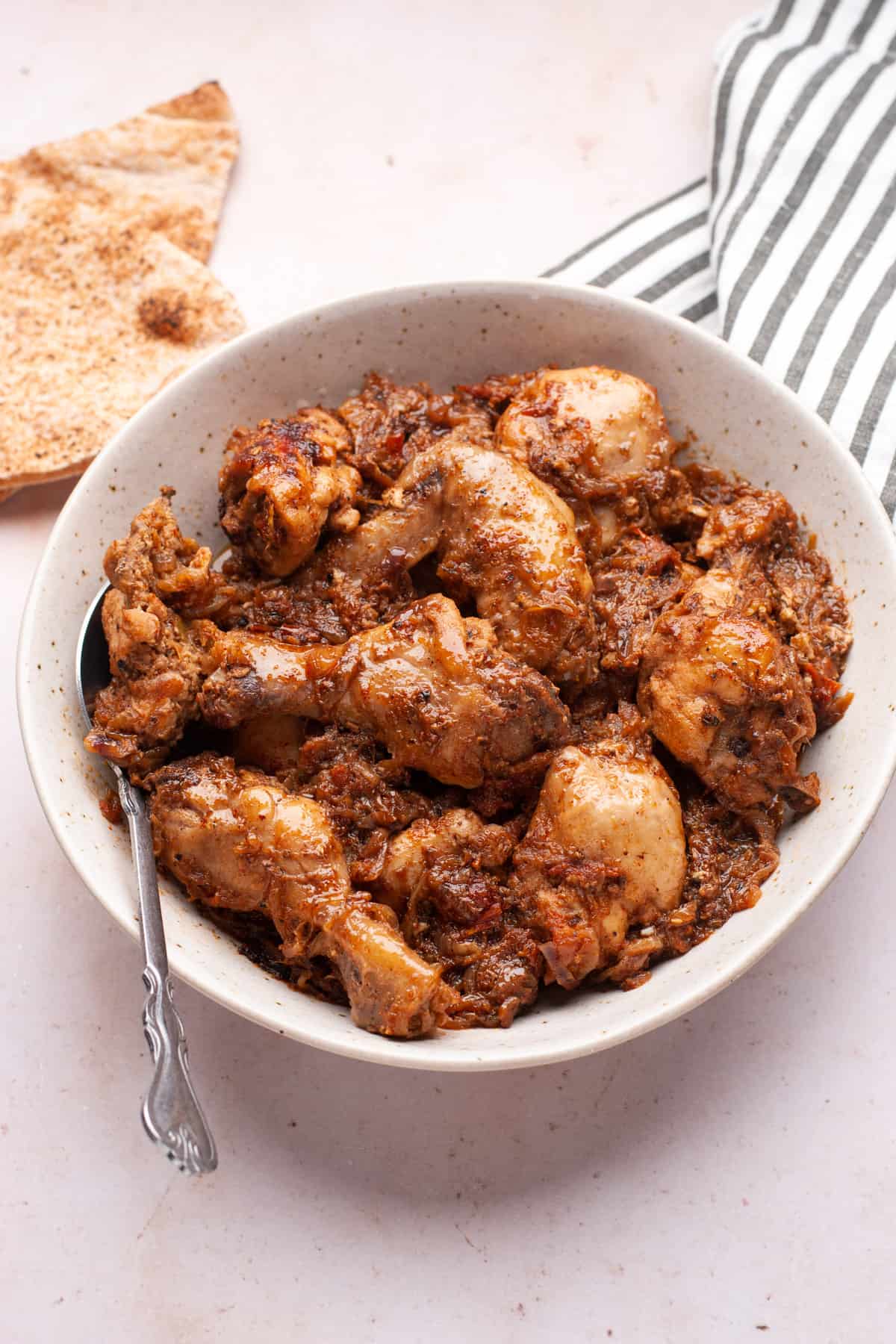 Chicken bhuna masala in a bowl with spoon.
